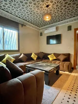 a living room with a couch and a table at Merzouga Hotel Lexpert 