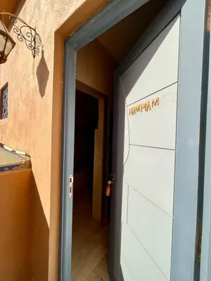 a garage door with the words hammondma mi written on it at Merzouga Hotel Lexpert 