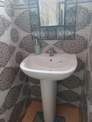a white sink in a bathroom with a mirror at Dar rachid ouzoud in Azilal