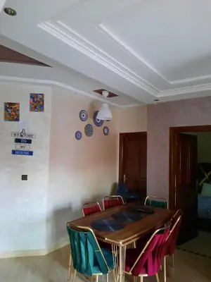 a dining room with a table and chairs at DARY in Fès