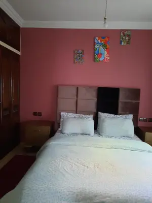 a bedroom with a large bed with two white pillows at DARY in Fès