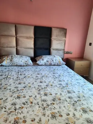 a bed with two pillows on it in a bedroom at DARY in Fès
