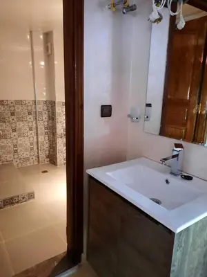 a bathroom with a sink and a shower at DARY in Fès