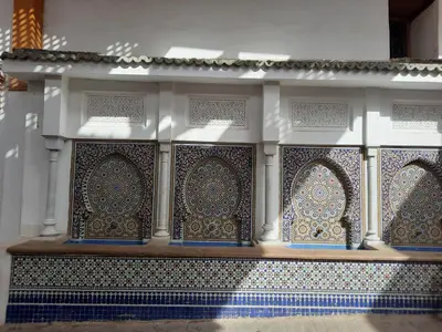 a building with blue and white tiles on the wall at DARY in Fès
