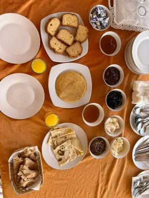a table with plates of food and desserts on it at Tamaris Camp in Hassilabied