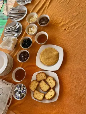a table with a plate of food with biscuits and dips at Tamaris Camp in Hassilabied
