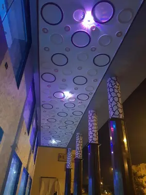 a room with a ceiling with purple lights on it at ZELLAKA hôtel & café in Khouribga