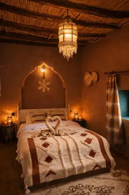 a bedroom with a bed with a swan on it at Casa Mona in Merzouga