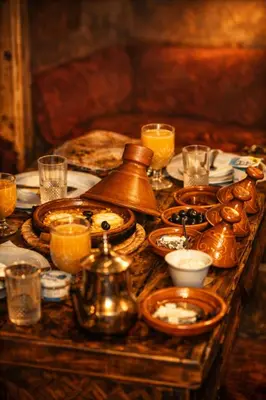a table with a tea kettle and plates of food at Casa Mona in Merzouga