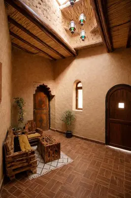 a living room with a couch and a table at Casa Mona in Merzouga