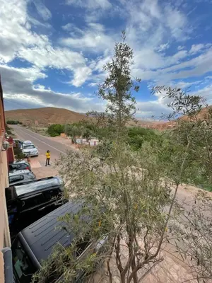 a truck parked on the side of a road in the desert at Maison D'hôte La Vallée Des Figues in Tamellalt