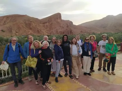 a group of people standing in front of a mountain at Maison D'hôte La Vallée Des Figues in Tamellalt