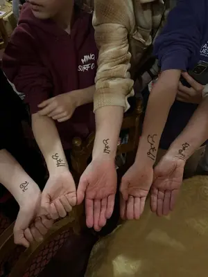 a group of people with tattoos on their hands at La Kasbah du Jardin in Aït Ben Haddou