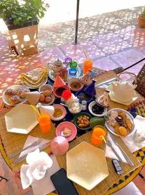 a table full of food and drinks on a table at La Kasbah du Jardin in Aït Ben Haddou
