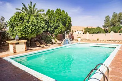 a swimming pool in a backyard with a swimming pool at La Kasbah du Jardin in Aït Ben Haddou