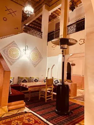 a room with a bed and a table in a room at Auberge Tissadrine in Akhendachou nʼAït Ouffi