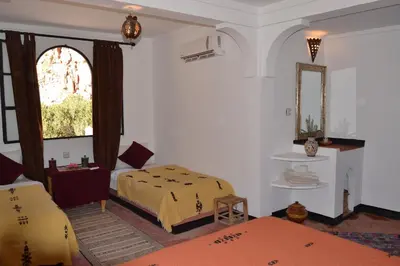 a bedroom with a bed and a window at Auberge Tissadrine in Akhendachou nʼAït Ouffi