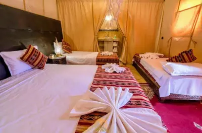a hotel room with two beds with bows at Night Luxury Dunes Camp in Merzouga