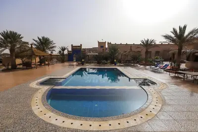 a large swimming pool in the middle of a resort at Ksar Bicha in Merzouga