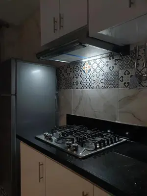 a kitchen with a stove and a refrigerator at White House in Azrou