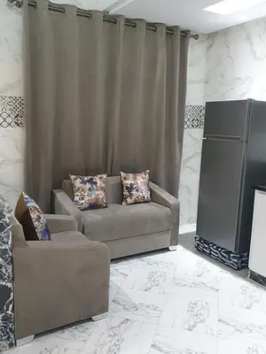 a living room with a couch and a television at White House in Azrou