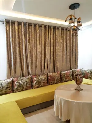 a yellow couch in a room with a table at White House in Azrou