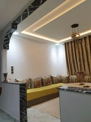 a living room with a yellow couch in a room at White House in Azrou