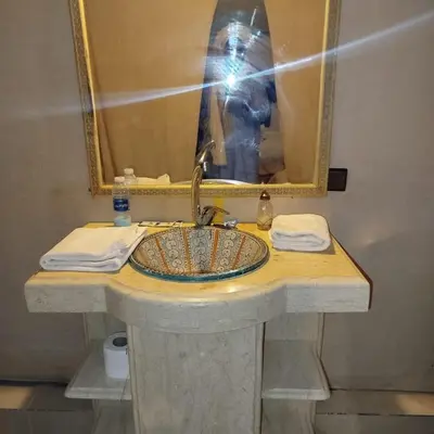 a person taking a picture of a bathroom sink at Desert Romantic Camp in Merzouga