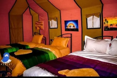 a room with two beds in a room at Desert Romantic Camp in Merzouga