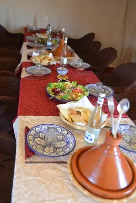 a long table with plates of food on it at Ame camp in Merzouga