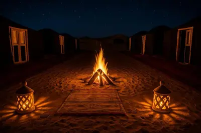 a campfire in the middle of the desert with two lights at Ame camp in Merzouga