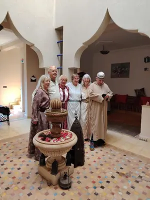 a group of people standing next to a fountain at Ourika lodge the healing place in Tafza