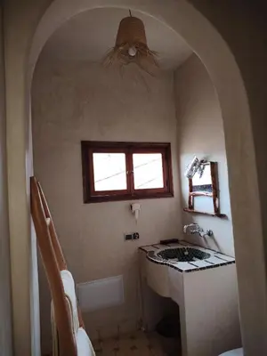 a small bathroom with a sink and a window at Ourika lodge the healing place in Tafza
