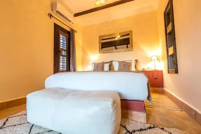 a bedroom with a large white bed in a room at Riad Madu in Merzouga