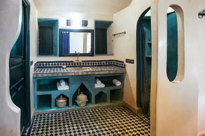 a bathroom with a sink and a mirror at Riad Madu in Merzouga