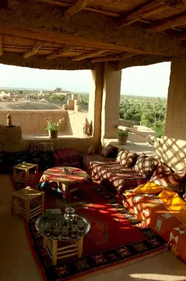 a living room with a couch and two tables at Auberge Migusta in Skoura