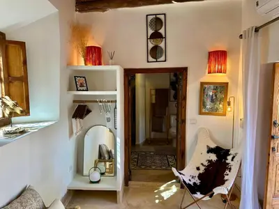 a living room with a chair and a mirror at VILLA BEL'VIE, PRIVEE, MARRAKECH , PISCINE CHAUFFEE, Wifi, Clim in Douar bel Rhanodour