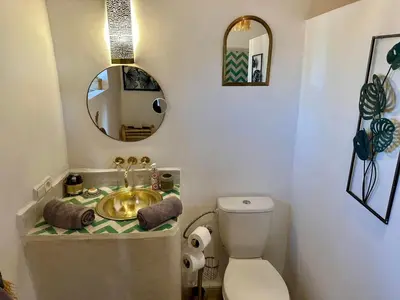 a bathroom with a sink and a toilet and a mirror at VILLA BEL'VIE, PRIVEE, MARRAKECH , PISCINE CHAUFFEE, Wifi, Clim in Douar bel Rhanodour