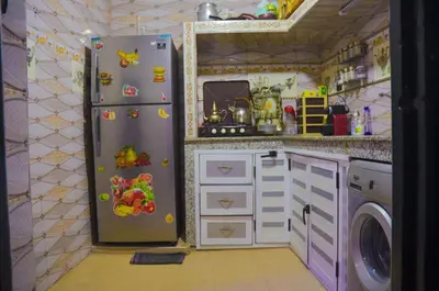 a kitchen with a refrigerator with magnets on it at LA casa Dar Rayan in Fès