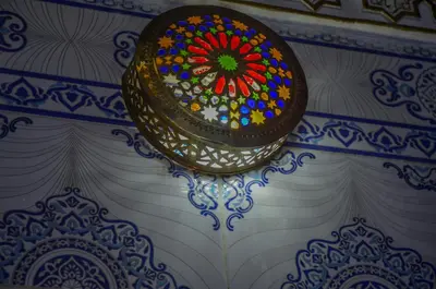 a stained glass window is hanging on a wall at LA casa Dar Rayan in Fès