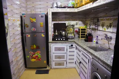 a small kitchen with a refrigerator and a sink at LA casa Dar Rayan in Fès