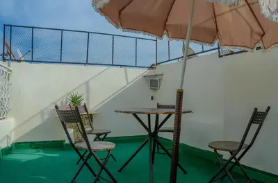 a table and chairs with an umbrella in a room at LA casa Dar Rayan in Fès