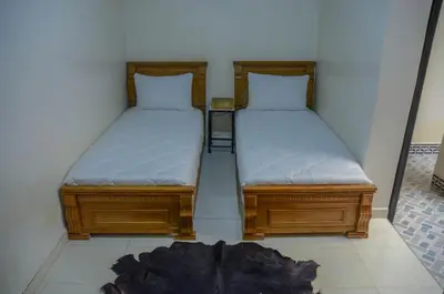 two beds sitting next to each other in a room at LA casa Dar Rayan in Fès