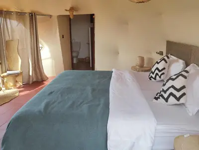 a bedroom with a large bed with pillows on it at Tatooine Stars Camp in Merzouga