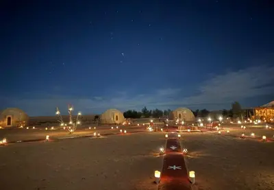 a group of lights in a field at night at Tatooine Stars Camp in Merzouga