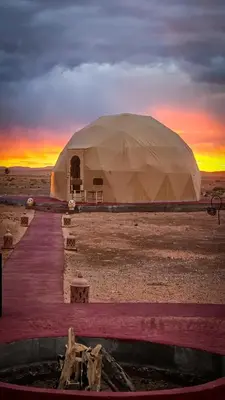 a large tent in the middle of the desert at Tatooine Stars Camp in Merzouga