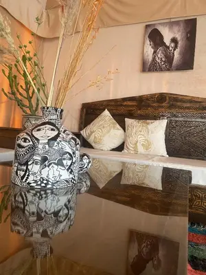 a vase sitting on top of a glass table at Sunrise Sahara Camp in Merzouga