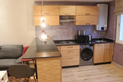 a kitchen with a washer and dryer in a room at Luxury Appartement Noor in Fès