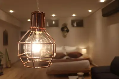 a glass pendant light hanging in a living room at Luxury Appartement Noor in Fès