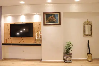 a living room with a flat screen tv on a wall at Luxury Appartement Noor in Fès